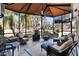 Inviting screened porch with comfortable seating, ceiling fan, and peaceful outdoor views with mature landscaping at 4515 Biggs Pl, The Villages, FL 32163
