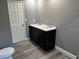 Bathroom with grey walls, wood-look flooring, and a double vanity at 4520 N Hiawassee Rd, Orlando, FL 32818