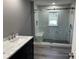 Modern bathroom with large walk-in shower, marble tile, and gray walls at 4520 N Hiawassee Rd, Orlando, FL 32818