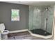 Bathroom with grey walls, wood-look flooring, and a glass shower enclosure at 4520 N Hiawassee Rd, Orlando, FL 32818