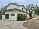 Side view of the house showcasing the garage and landscaping at 4520 N Hiawassee Rd, Orlando, FL 32818