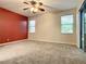 Bedroom with ceiling fan and access to balcony at 4985 Rainbow Trout Rd, Tavares, FL 32778