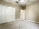 Spacious bedroom with neutral walls, carpet flooring and a double door closet at 4985 Rainbow Trout Rd, Tavares, FL 32778