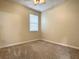 Bright bedroom with neutral walls, carpet flooring, and a window with blinds at 4985 Rainbow Trout Rd, Tavares, FL 32778