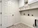 Bright laundry room with built-in cabinets and tile floor at 4985 Rainbow Trout Rd, Tavares, FL 32778