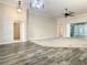 Open living room with high ceilings, wood-look tile, and carpet at 4985 Rainbow Trout Rd, Tavares, FL 32778