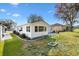 A view of the home's exterior with well-kept lawn and gardens on a sunny day at 525 Bonita Dr, Lady Lake, FL 32159