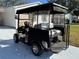 Image of a covered golf cart in good condition, viewed from the rear at 525 Bonita Dr, Lady Lake, FL 32159