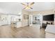 Open concept living room with view of kitchen with breakfast bar and access to sun room through french doors at 525 Bonita Dr, Lady Lake, FL 32159