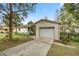 Front view of the house, highlighting the attached garage and driveway at 5301 Se 115Th Pl, Belleview, FL 34420