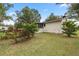 View of the back of the house and surrounding landscape at 5301 Se 115Th Pl, Belleview, FL 34420