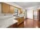 Galley kitchen with wood cabinets and laminate countertops at 5301 Se 115Th Pl, Belleview, FL 34420