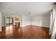 Open living room with hardwood floors and a view into the kitchen and dining area at 5301 Se 115Th Pl, Belleview, FL 34420