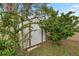 Metal storage shed nestled among lush greenery at 5301 Se 115Th Pl, Belleview, FL 34420