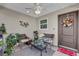 Covered porch with wicker furniture and a welcome mat at 6206 Dingman Way, The Villages, FL 32163