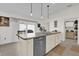 Kitchen island with sink, dishwasher, and storage at 6206 Dingman Way, The Villages, FL 32163