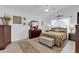 Main bedroom with a king-size bed, large dresser, and plenty of natural light at 6206 Dingman Way, The Villages, FL 32163