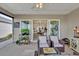 Bright screened porch with sliding glass doors leading to the dining area at 6206 Dingman Way, The Villages, FL 32163