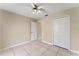 Bright bedroom featuring tile floors and double door closet at 6739 Lorain Street, Orlando, FL 32810