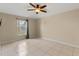 Simple bedroom with tile flooring and neutral-colored walls at 6739 Lorain Street, Orlando, FL 32810