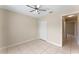 Well-lit bedroom with tile floors and ceiling fan at 6739 Lorain Street, Orlando, FL 32810