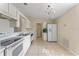 Kitchen with white cabinets, tile flooring, and modern appliances at 6739 Lorain Street, Orlando, FL 32810