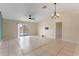 Living room with tile flooring, sliding glass doors, and neutral decor at 6739 Lorain Street, Orlando, FL 32810