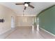 Spacious living room with tile flooring, ceiling fan, and neutral colors at 6739 Lorain Street, Orlando, FL 32810