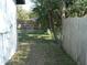 Backyard with wooden fence and trees at 703 Sullivan Ave, Ocoee, FL 34761