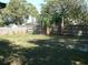 Large backyard with a wood fence and mature trees for privacy at 703 Sullivan Ave, Ocoee, FL 34761