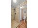 Bathroom with walk-in shower, toilet, and hardwood floors at 705 Devon Dr, Lady Lake, FL 32159