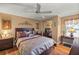 Primary bedroom with ceiling fan and wood flooring at 705 Devon Dr, Lady Lake, FL 32159