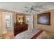 Bedroom with dresser and views of laundry and kitchen at 705 Devon Dr, Lady Lake, FL 32159