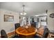 Dining room with wood table and chairs, view of kitchen at 705 Devon Dr, Lady Lake, FL 32159