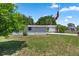 Single-wide home with grassy yard and flagpole at 705 Devon Dr, Lady Lake, FL 32159