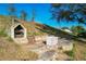 Outdoor BBQ area with stone structure and steps at 733 Cherry Laurel St, Minneola, FL 34715