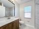 Modern bathroom with a wood vanity and marble shower at 733 Cherry Laurel St, Minneola, FL 34715