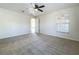 Spacious bedroom with ceiling fan and neutral carpeting at 733 Cherry Laurel St, Minneola, FL 34715