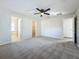 Large bedroom with ceiling fan, carpet, and ensuite bathroom at 733 Cherry Laurel St, Minneola, FL 34715