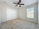 Spacious bedroom with neutral walls, ceiling fan, and large closet at 733 Cherry Laurel St, Minneola, FL 34715