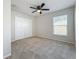 Spacious bedroom with neutral walls, ceiling fan, and large closet at 733 Cherry Laurel St, Minneola, FL 34715