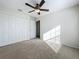 Spacious bedroom with neutral walls, ceiling fan, and large closet at 733 Cherry Laurel St, Minneola, FL 34715