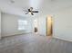 Large bedroom with ceiling fan, carpet, and ensuite bathroom at 733 Cherry Laurel St, Minneola, FL 34715