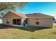 Tan house exterior with screened porch and brown roof at 733 Cherry Laurel St, Minneola, FL 34715