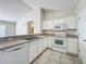 White cabinets, granite countertops and stainless steel appliances in this bright kitchen at 733 Cherry Laurel St, Minneola, FL 34715