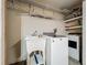 Laundry room with washer, dryer, utility sink, and shelving at 733 Cherry Laurel St, Minneola, FL 34715