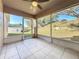 Bright screened porch with tile flooring and ceiling fan, offering backyard views at 733 Cherry Laurel St, Minneola, FL 34715