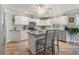 White kitchen with granite countertops and kitchen island at 7592 Se 170Th Longview Ln, The Villages, FL 32162