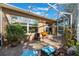 Relaxing screened patio with brick flooring and potted plants at 7592 Se 170Th Longview Ln, The Villages, FL 32162