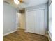 Bedroom with double door closet and wood-look floors at 8 Dogwood Circle Pl, Ocala, FL 34472